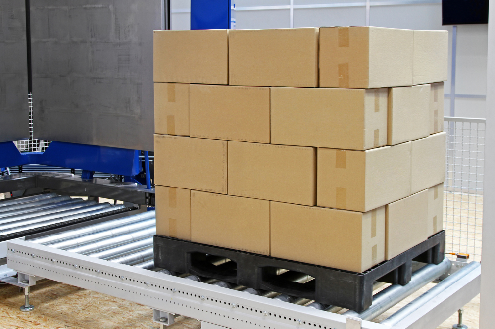 A stack of pharmaceutical boxes on a pallet, ready for distribution in a warehouse setting.